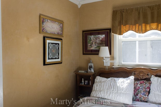 A bedroom with a bed and a painting on the wall