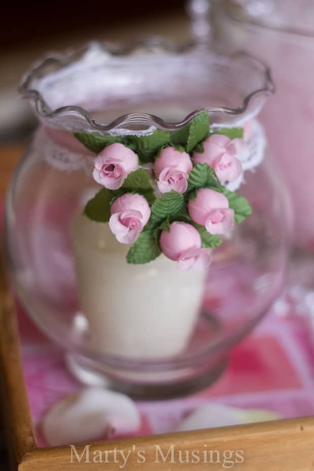 A close up of a glass vase filled with pink flowers, with Home and Holiday