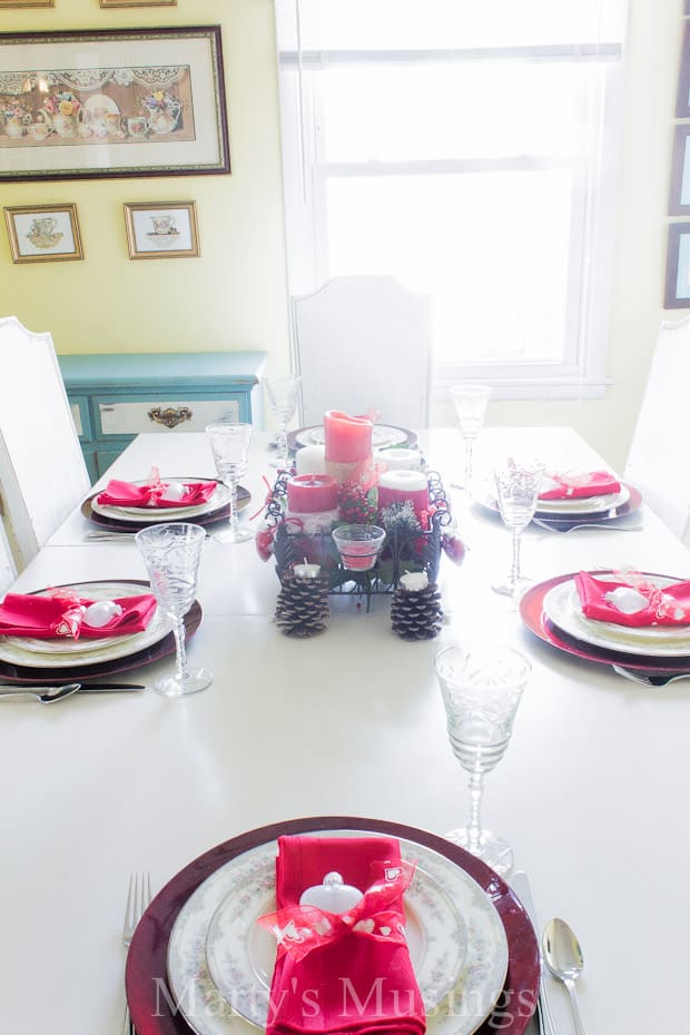 A dining table with a cake on a plate, with Valentine's Day and Anniversary