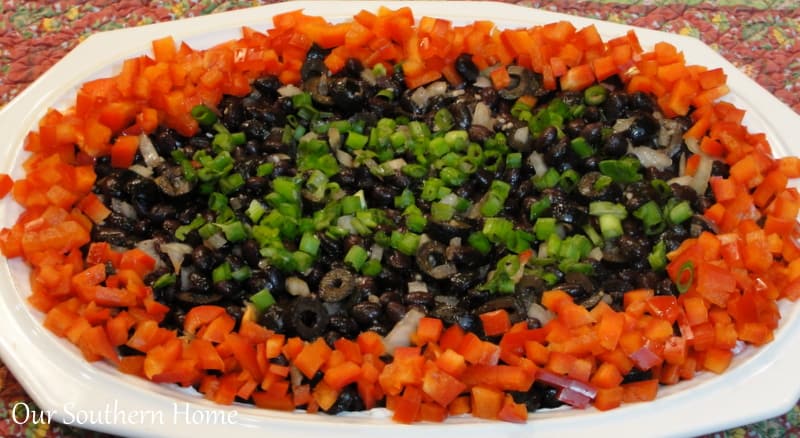 A plate of food with rice meat and vegetables, with Home and Party