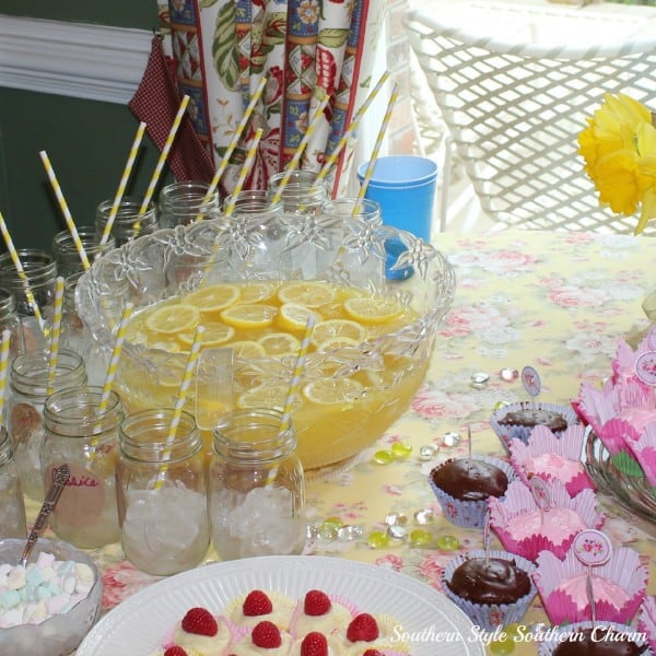 A plate full of food sitting on a table, with Lemonade and Punch