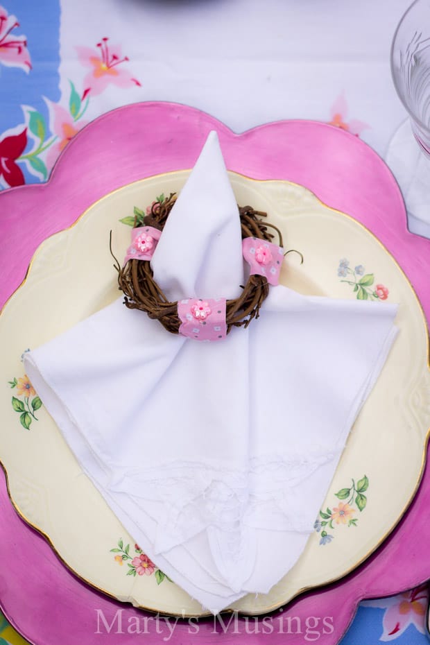 A pink cake on a plate, with Napkin and Duck Brand