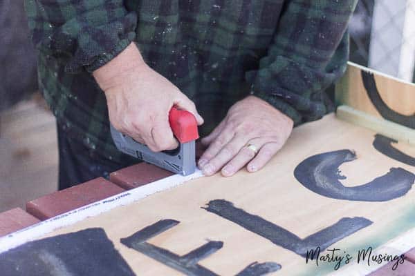 Stapling fabric to plywood