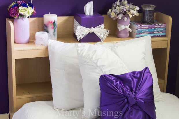 A double bed with a purple flower