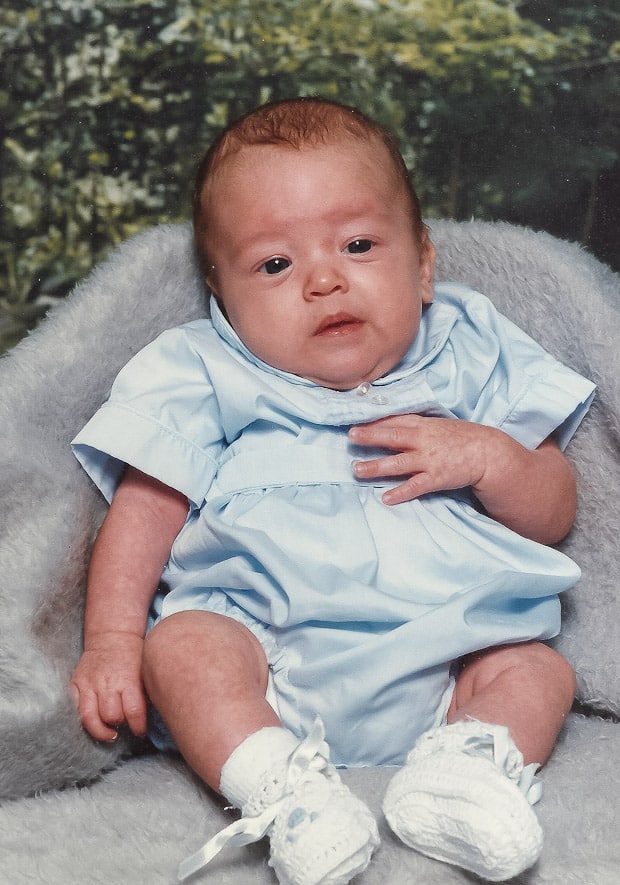 A baby sitting on a blanket