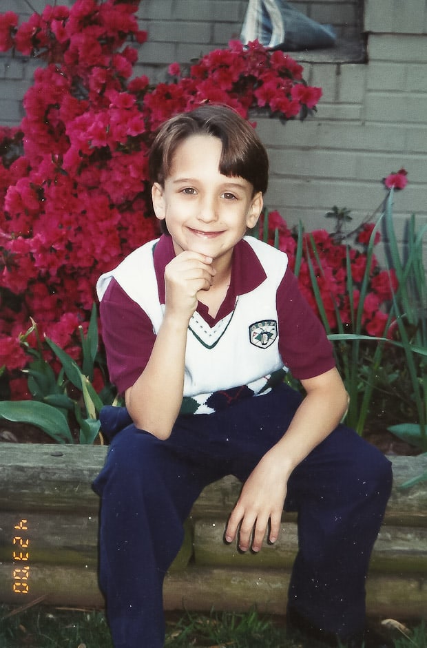 A young boy sitting on a bench