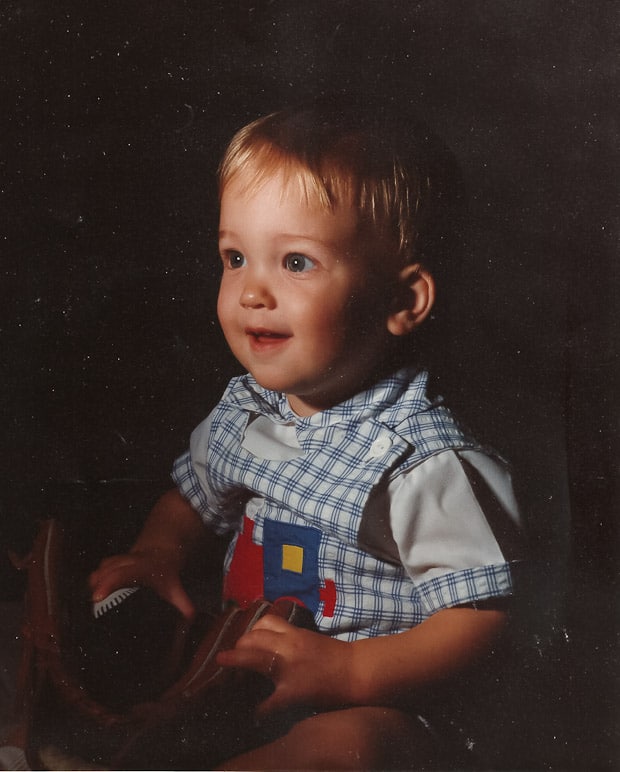 A little boy sitting on a table