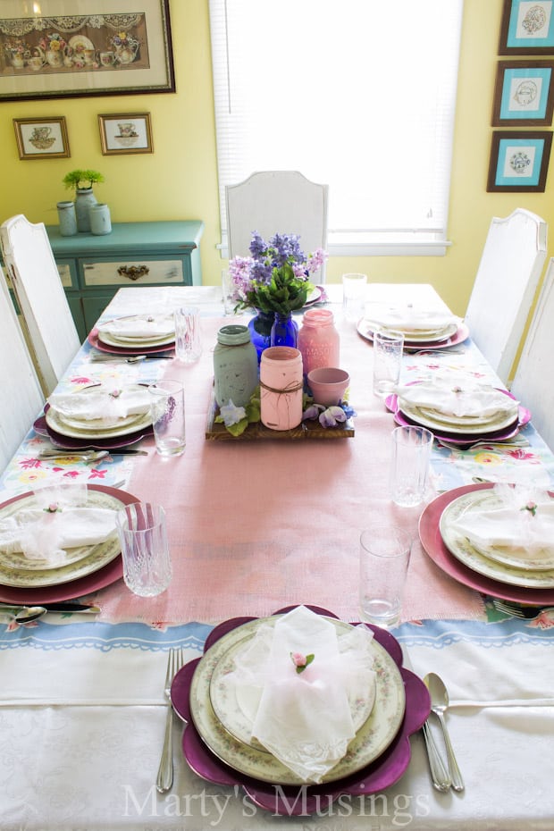 A dining table with a cake on a plate, with Party and Room