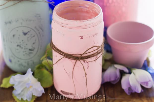 A cup of coffee on a table, with Mason jar