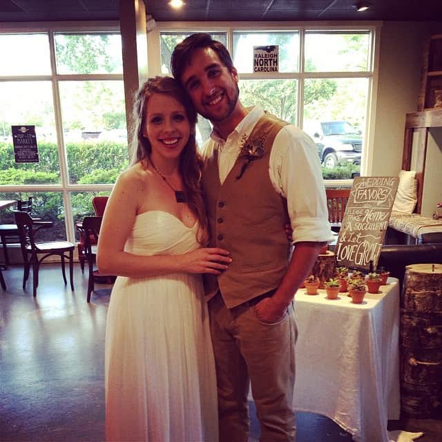 A man and a woman standing in front of a window, with Sara Groves