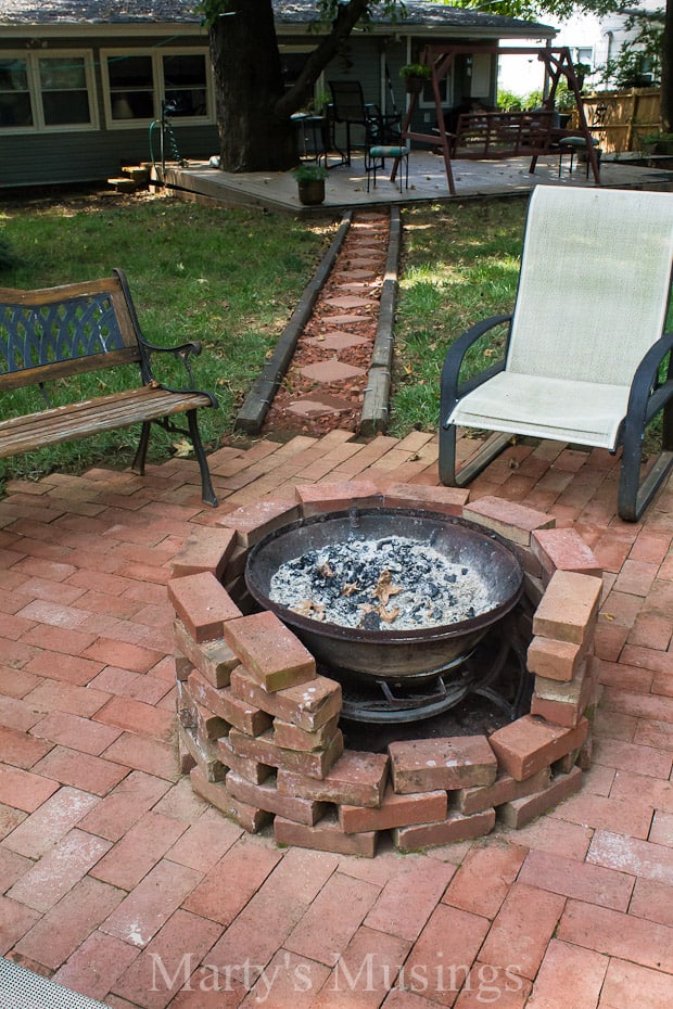 A stone bench sitting next to a brick wall