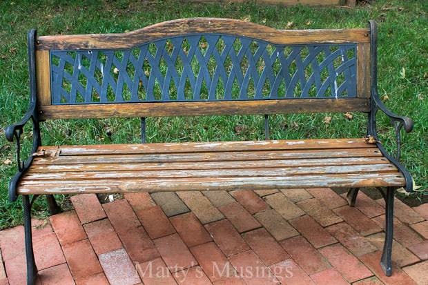 An empty wooden bench sitting in the middle of a park