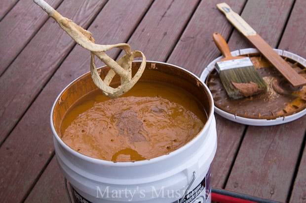 A cup of coffee sitting on top of a wooden table, with Deck and Behr