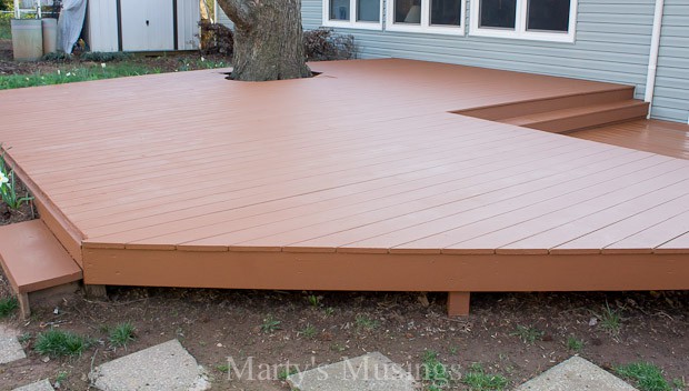 A wooden bench sitting in front of a house