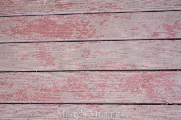 Wood deck with peeling stain in need of restoring and cleaning.