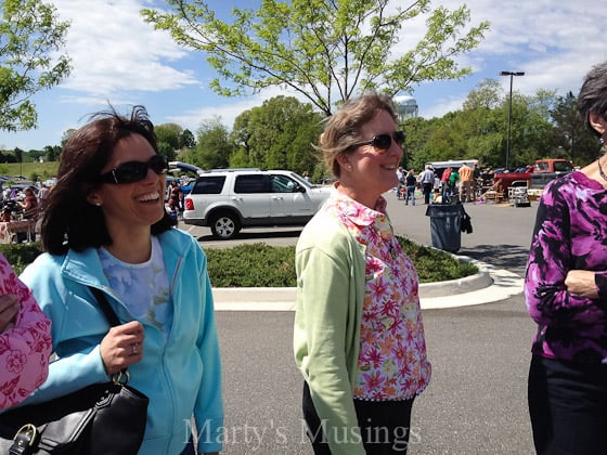 A group of people standing next to a woman at a park