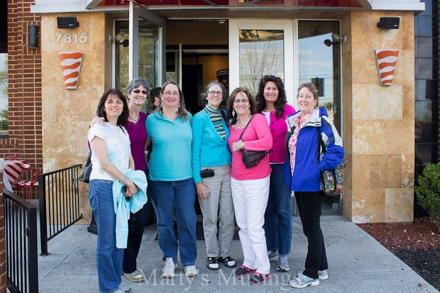 A group of people posing in front of a building