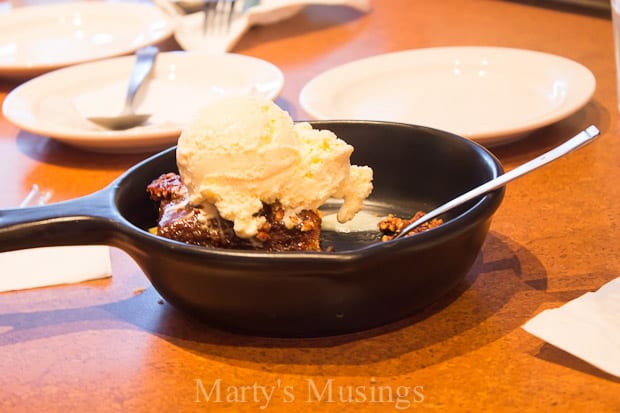 A bowl of food on a plate on a table