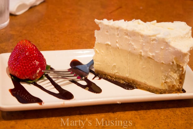 A piece of chocolate cake on a plate, with Cheesecake