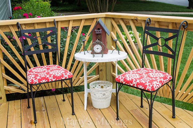 Black metal chairs with red fabric on newly built deck