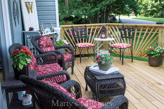 Unstained deck decorated with furniture and flowers