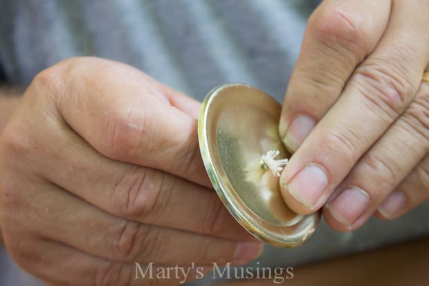 creating hold in mason jar lid for Citronella Candles 