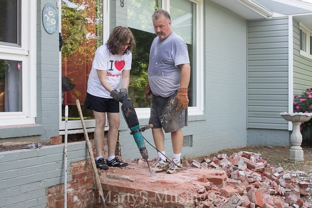 A man standing in front of a brick building