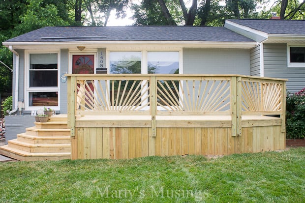 A house with a lawn and newly built front deck