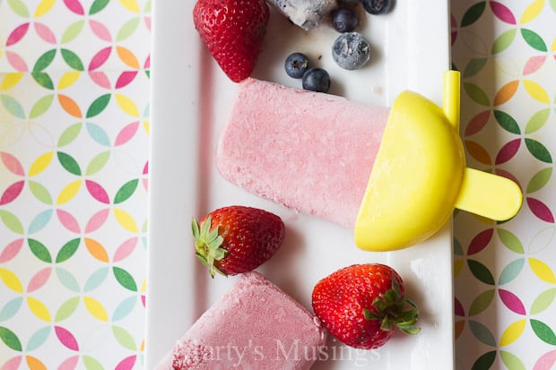 A cake with fruit on a plate, with Strawberry and Smoothie