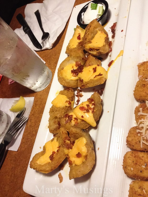 A plate of food on a table, with Dipping sauce and Dumpling