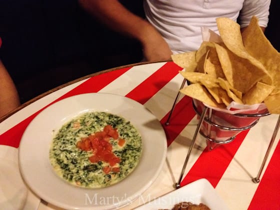 A person holding a plate of food, with Guacamole