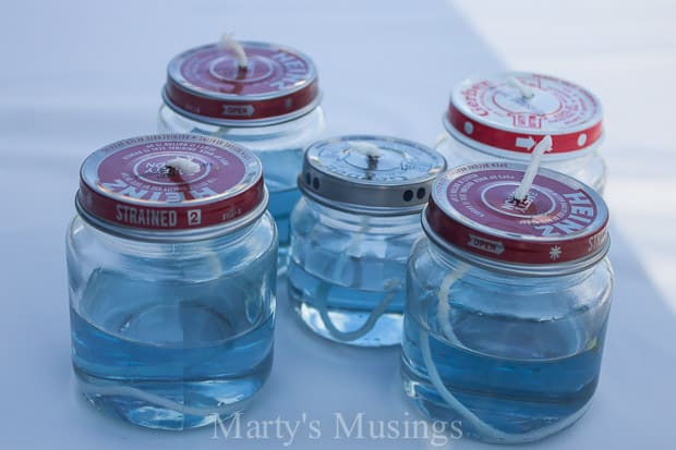 A close up of baby food jars with blue liquid