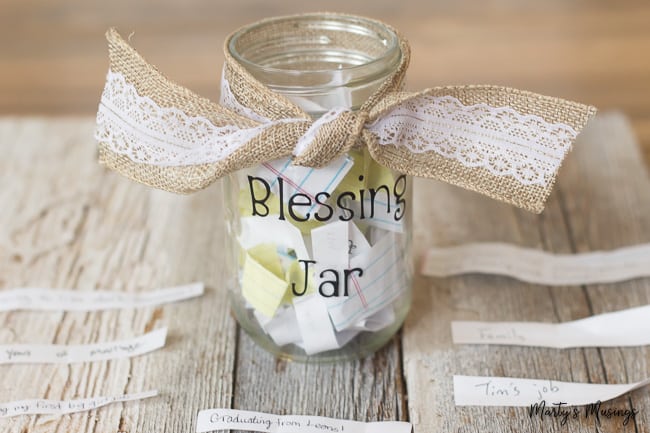 blessing jar with burlap ribbon and slips of paper with blessings