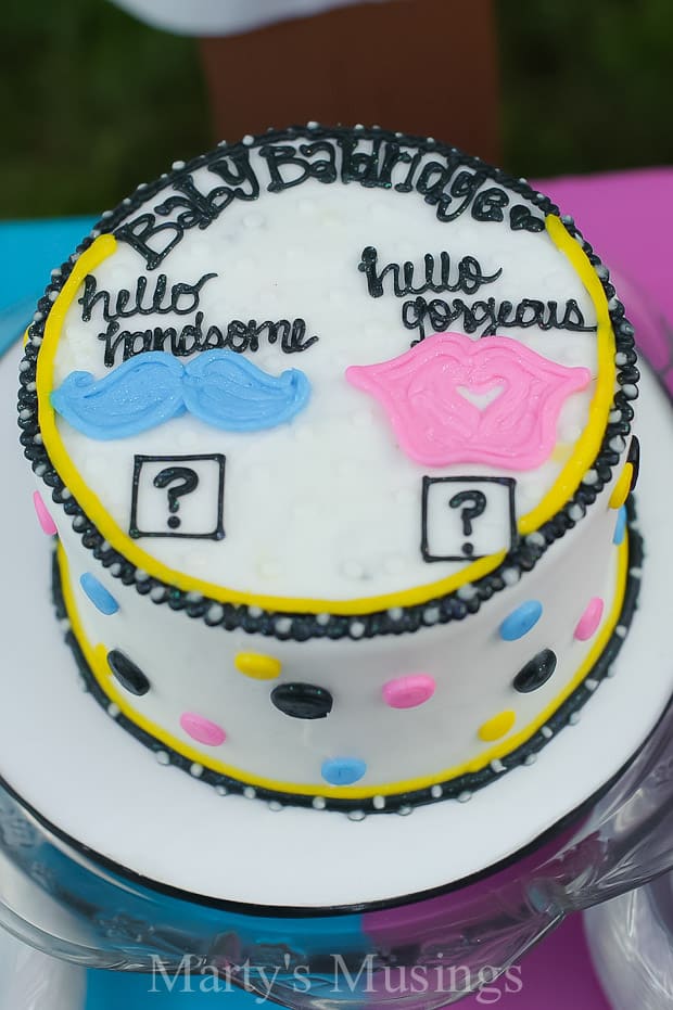 Gender reveal cake with blue, pink and black decorations