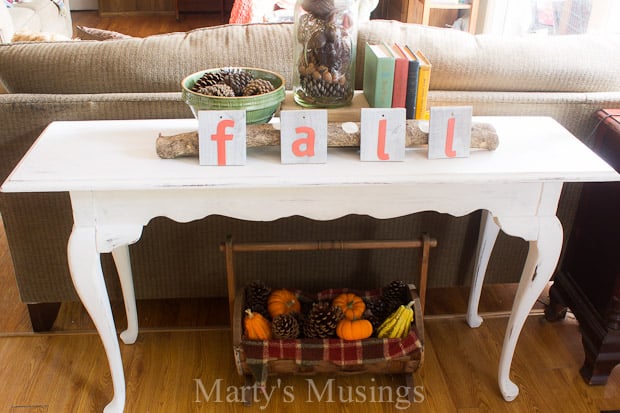 A living room filled with furniture and vase of flowers on a table