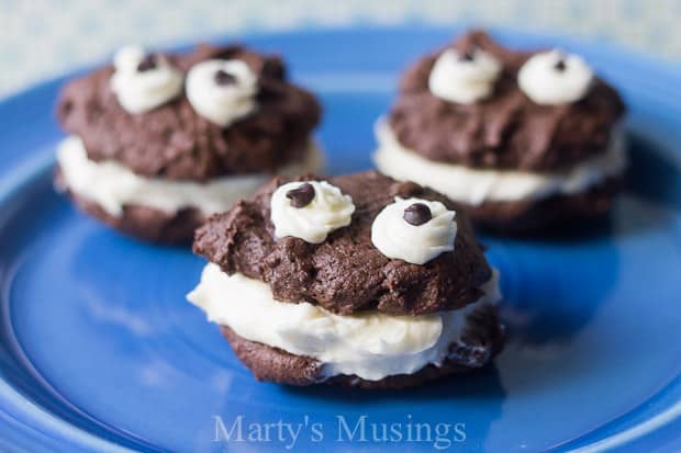 A close up of a chocolate cake on a blue plate, with Cookie and Cream