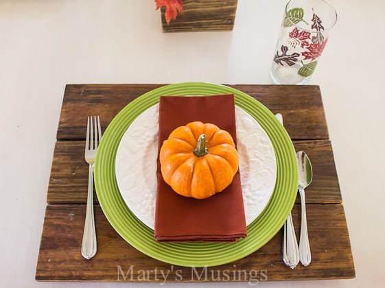 A salad sitting on top of a wooden table, with Thanksgiving dinner