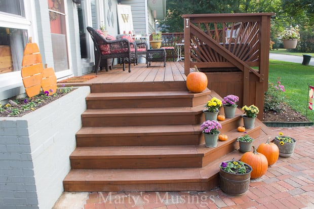 An orange bench in front of a brick building