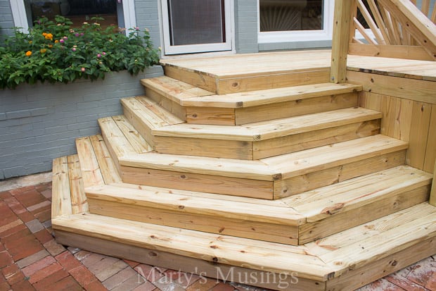 A wooden bench in front of a house