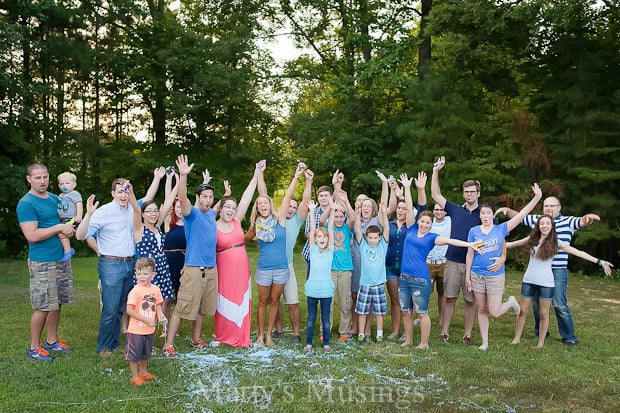 A group of people that are standing in the grass