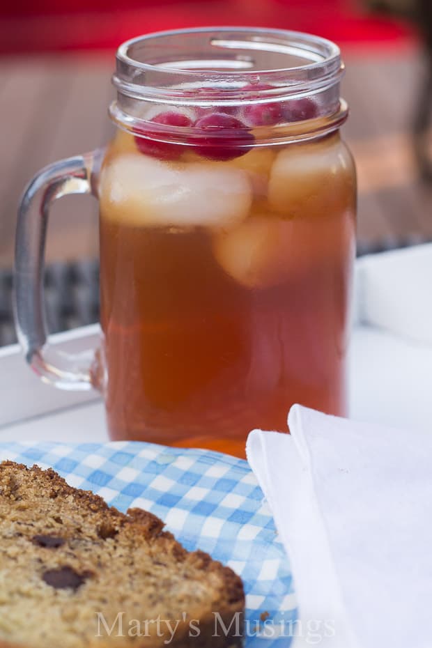 A glass of orange juice next to a cup of coffee, with Sweet tea