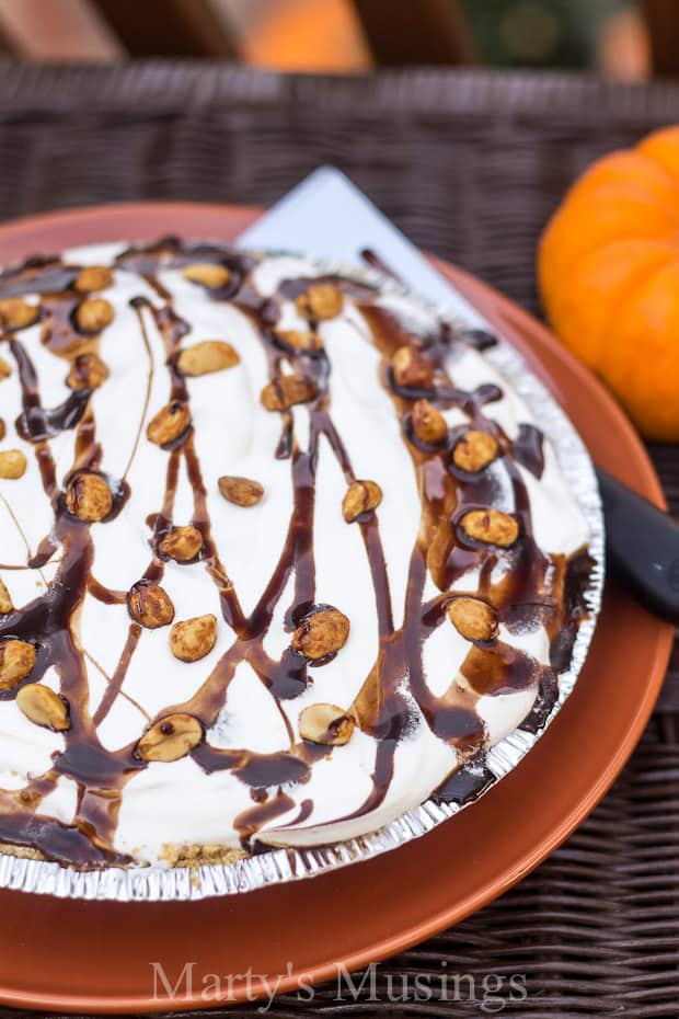 A large chocolate cake on a plate, with Pie and Thanksgiving