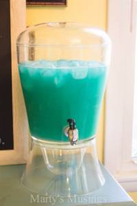 A glass with a blue cup, with Party and Punch