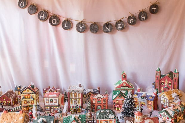 Christmas village with O Holy Night chalkboard banner hanging above