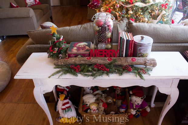 A living room filled with furniture and vase of flowers on a table