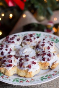 A slice of pizza on a plate, with Cinnamon roll and Cake