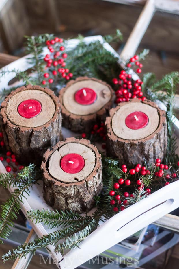 log candle holders with red tea light candles