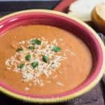 A bowl of soup, with Basil and Tomato