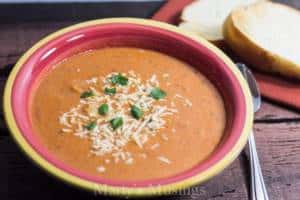 A bowl of soup, with Basil and Tomato