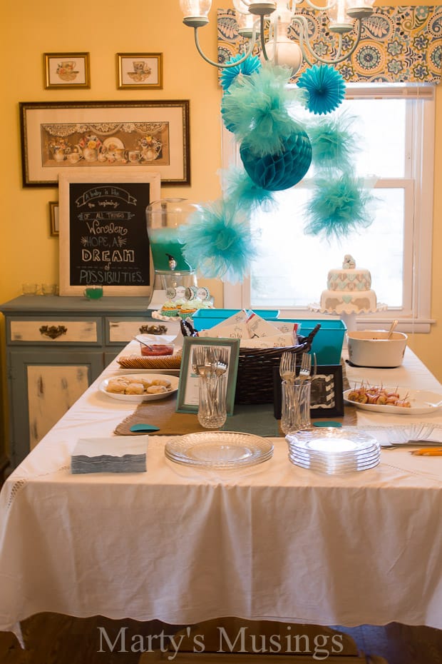 dining room table with blue party decorations hanging over table